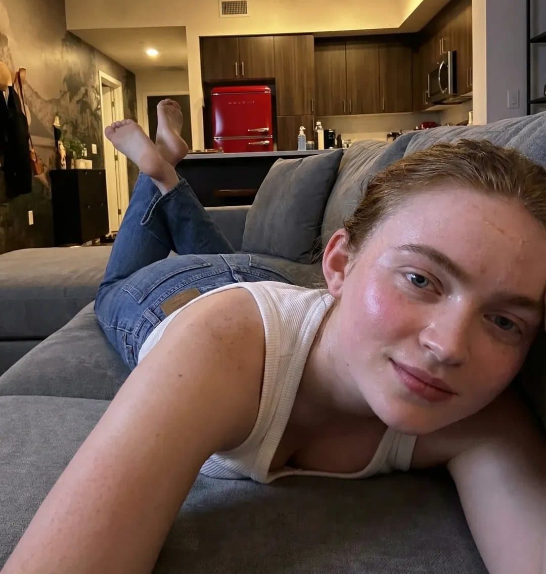 Woman Lounging on Sofa in Modern Apartment
