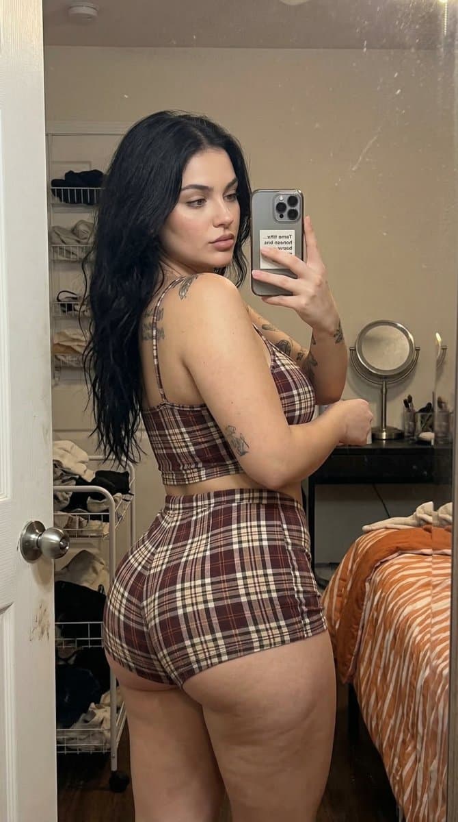 Mirror Selfie of a Young Woman with Tattoos