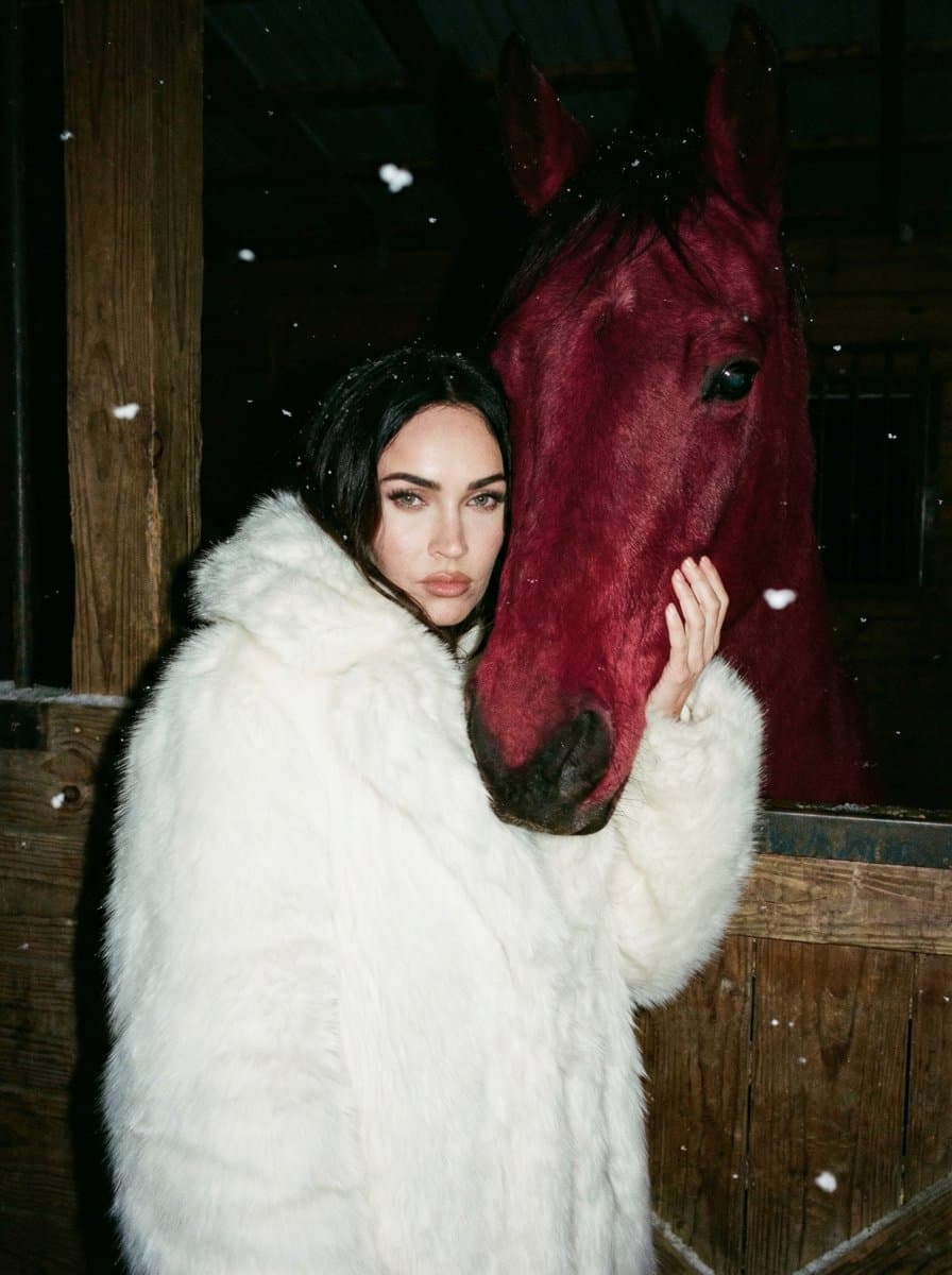 Woman in White Fur with Crimson Horse in Stable