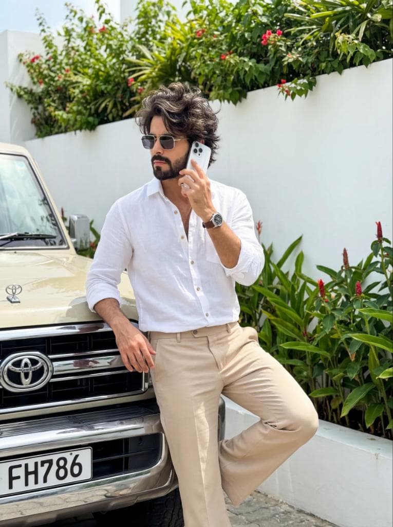 Stylish Boy with iPhone Leaning on Land Cruiser